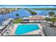Aerial view of a community pool and marina, offering resort-style amenities with views of the scenic harbor at 4420 Marine Pkwy, New Port Richey, FL 34652