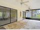 Large sunroom with textured walls and multiple sliding glass door access points showcasing a bright interior at 4420 Marine Pkwy, New Port Richey, FL 34652