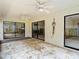 Bright sunroom with textured walls, ceiling fans, and sliding glass doors providing access to exterior views at 4420 Marine Pkwy, New Port Richey, FL 34652