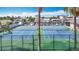 Close up of well-maintained tennis courts and lush greenery within the community at 4420 Marine Pkwy, New Port Richey, FL 34652