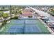 Aerial view of community tennis courts with direct water access to the canal and waterfront properties at 4420 Marine Pkwy, New Port Richey, FL 34652