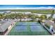 Overhead shot of well-kept community tennis courts with surrounding landscaping and parking, near the marina at 4420 Marine Pkwy, New Port Richey, FL 34652