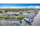 Aerial view of the Gulf Harbour Yacht Club with boat docks, a well-manicured lawn, and the community pool at 4420 Marine Pkwy, New Port Richey, FL 34652