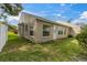 Backyard showing rear exterior with multiple windows and grass at 4837 Boonesboro Ct, New Port Richey, FL 34655