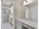 Bathroom featuring dual vanity and access to a shower at 4837 Boonesboro Ct, New Port Richey, FL 34655
