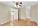 Bedroom featuring wood floors, ceiling fan, and access to bathroom at 4837 Boonesboro Ct, New Port Richey, FL 34655