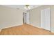 Bright bedroom features a ceiling fan, and wood-look laminate flooring and a large closet at 4837 Boonesboro Ct, New Port Richey, FL 34655