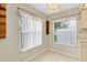 Dining area featuring two windows with white blinds and light colored tile flooring at 4837 Boonesboro Ct, New Port Richey, FL 34655