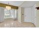 Bright entryway featuring tile flooring, a chandelier, and a storm door at 4837 Boonesboro Ct, New Port Richey, FL 34655
