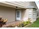 Inviting front porch features tiled flooring, a white front door, and mature landscaping at 4837 Boonesboro Ct, New Port Richey, FL 34655