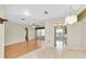 Open-concept living area with tile and wood flooring, seamlessly connecting to the dining and kitchen at 4837 Boonesboro Ct, New Port Richey, FL 34655