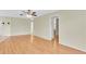 Bright living room with wood floors leading to hallway and bathroom at 4837 Boonesboro Ct, New Port Richey, FL 34655