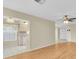 Open-concept living space with wood-look floors, ceiling fan, and views of the kitchen at 4837 Boonesboro Ct, New Port Richey, FL 34655