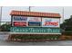 Shopping center sign in Grand Trinity Plaza, featuring popular restaurants and fitness centers at 4837 Boonesboro Ct, New Port Richey, FL 34655