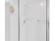 All white tile shower with shower head and glass door at 4837 Boonesboro Ct, New Port Richey, FL 34655