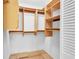 Spacious walk-in closet featuring built-in wood shelving and ample storage space at 4837 Boonesboro Ct, New Port Richey, FL 34655