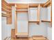 Spacious walk-in closet featuring built-in wood shelving and ample storage space at 4837 Boonesboro Ct, New Port Richey, FL 34655