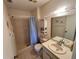 Bathroom with shower and tub with decorative white shelves and ample lighting above the sink at 4903 Myrtle Oak Dr # 12, New Port Richey, FL 34653