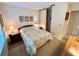 Relaxing bedroom with a window, carpeted floors, and soft lighting with closet and bathroom nearby at 4903 Myrtle Oak Dr # 12, New Port Richey, FL 34653