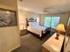 Comfortable bedroom featuring a ceiling fan and a large window overlooking the outdoors at 4903 Myrtle Oak Dr # 12, New Port Richey, FL 34653