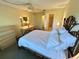 Cozy bedroom featuring a ceiling fan and an attached bathroom for added convenience at 4903 Myrtle Oak Dr # 12, New Port Richey, FL 34653