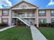 Charming two-story condo exterior featuring well-maintained landscaping and a welcoming entrance at 4903 Myrtle Oak Dr # 12, New Port Richey, FL 34653
