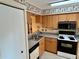 Efficient kitchen layout, featuring updated appliances and ample counter space, perfect for cooking and meal preparation at 4903 Myrtle Oak Dr # 12, New Port Richey, FL 34653