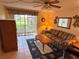 Comfortable living room with access to the screened-in patio with views of lush surroundings at 4903 Myrtle Oak Dr # 12, New Port Richey, FL 34653