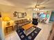 Comfortable living room with a ceiling fan, tile flooring, and view into the dining area at 4903 Myrtle Oak Dr # 12, New Port Richey, FL 34653