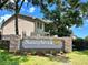 Attractive community signage for Sunnybrook, surrounded by well-manicured lawns and lush greenery at 4903 Myrtle Oak Dr # 12, New Port Richey, FL 34653