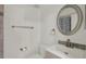 Updated bathroom features new vanity and decorative mirror with modern fixtures at 4939 Floramar Ter # 204, New Port Richey, FL 34652