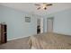 Bright bedroom features ceiling fan, carpeted floor, and a comfortable bed with decorative bedding at 4939 Floramar Ter # 204, New Port Richey, FL 34652