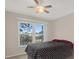 This bright bedroom has a large window and a ceiling fan at 4939 Floramar Ter # 204, New Port Richey, FL 34652