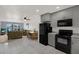 Open-concept kitchen with gray cabinets, appliances, and seamless flow to the living and dining areas at 4939 Floramar Ter # 204, New Port Richey, FL 34652
