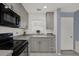 Updated kitchen featuring granite countertops, stainless steel appliances, and ample cabinet space for meal preparation at 4939 Floramar Ter # 204, New Port Richey, FL 34652