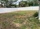 Spacious backyard with a white vinyl fence and green grass at 5023 Queen Palm Dr, New Port Richey, FL 34652