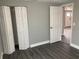 Bedroom featuring dark wood-look floors and a closet at 5023 Queen Palm Dr, New Port Richey, FL 34652