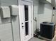 Exterior door with a window pane and a large HVAC unit at 5023 Queen Palm Dr, New Port Richey, FL 34652