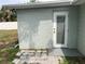 Exterior door with a window pane and stone walkway at 5023 Queen Palm Dr, New Port Richey, FL 34652