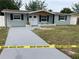 Charming exterior elevation with fresh gray driveway, white front door and blue shutters at 5023 Queen Palm Dr, New Port Richey, FL 34652