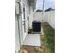 Exterior door with a HVAC unit and a white vinyl fence at 5023 Queen Palm Dr, New Port Richey, FL 34652