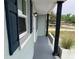 Exterior porch with support beams and blue shutters framing a large window at 5023 Queen Palm Dr, New Port Richey, FL 34652