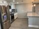 Modern kitchen with granite countertops, white cabinets, and stainless steel appliances at 5023 Queen Palm Dr, New Port Richey, FL 34652