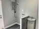 Functional laundry area with gray walls and a decorative sink backsplash at 5023 Queen Palm Dr, New Port Richey, FL 34652