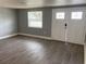 Inviting living room with light gray walls and matching gray floors at 5023 Queen Palm Dr, New Port Richey, FL 34652