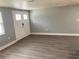 Spacious living room featuring modern gray walls and gray flooring at 5023 Queen Palm Dr, New Port Richey, FL 34652