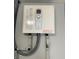 Tankless water heater installation in a utility area at 5023 Queen Palm Dr, New Port Richey, FL 34652