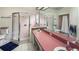 Bathroom featuring a double sink vanity with a pink countertop and enclosed shower at 5152 Panther Dr, Spring Hill, FL 34607