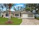 Charming single-story home features a well-manicured lawn and a paver driveway leading to an attached two-car garage at 5152 Panther Dr, Spring Hill, FL 34607