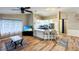 Open-concept kitchen boasts white cabinets, a breakfast bar, and stainless steel appliances adjacent to the living area at 5152 Panther Dr, Spring Hill, FL 34607